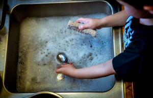 kid washing by sink